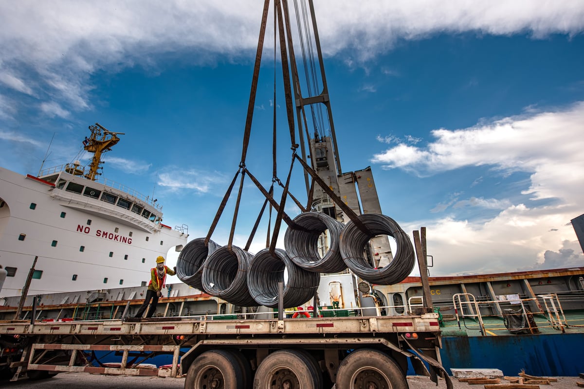 Bundled reinforcing steel staged for export cargo planning.