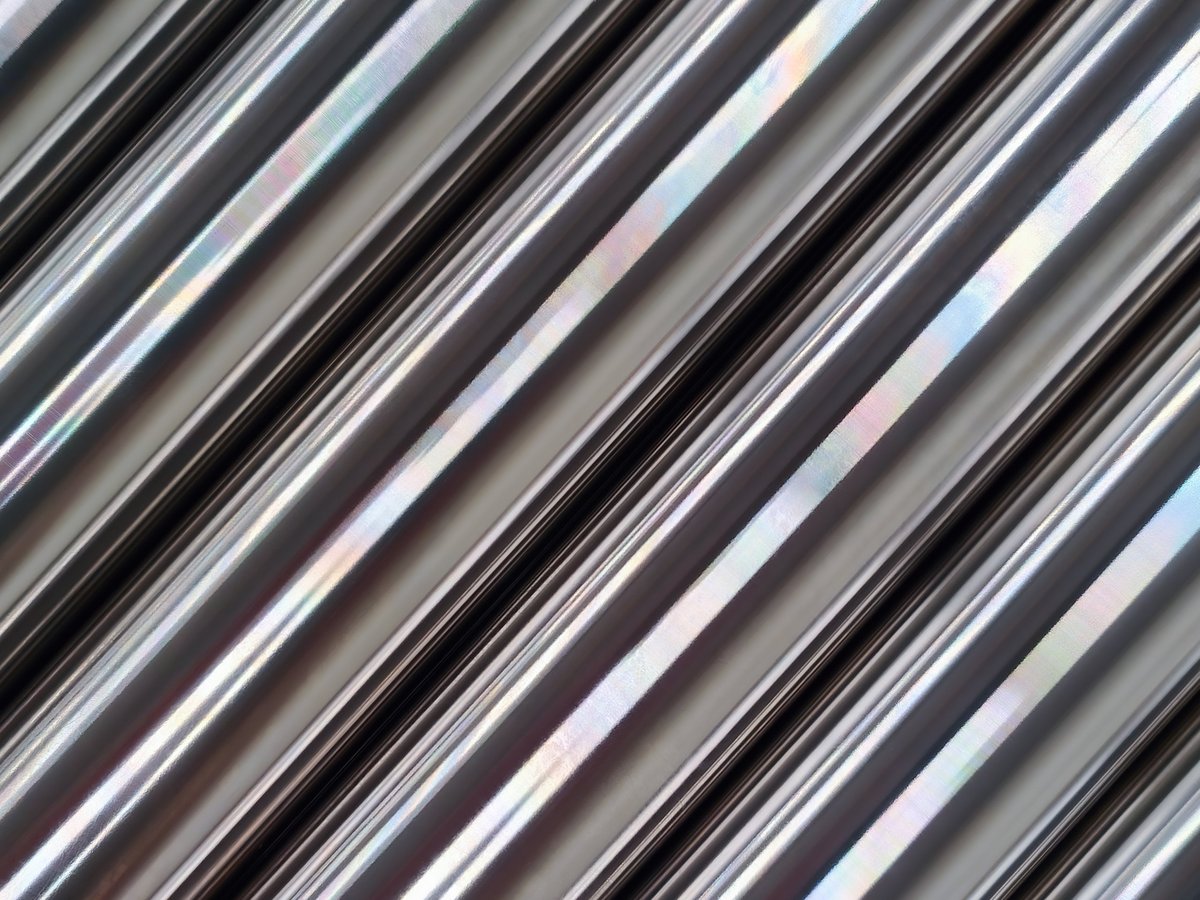 Bright polished stainless steel pipes in an industrial setting for commercial and logistics planning