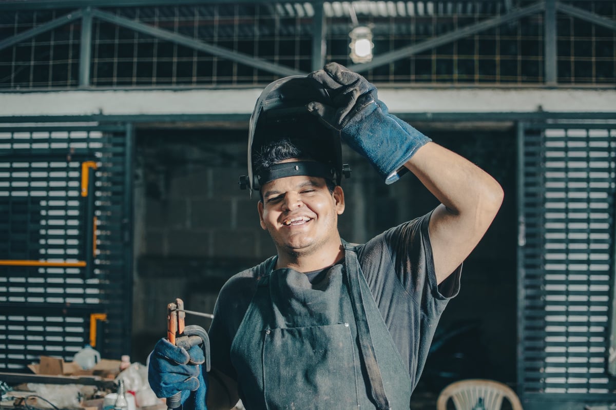 Welder preparing an alloy steel joint in a fabrication workshop