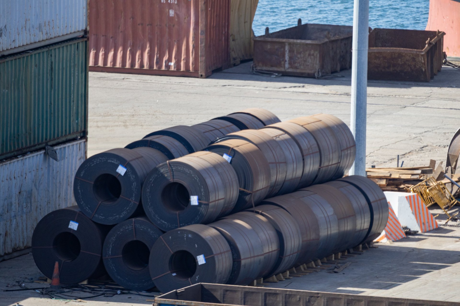 Construction material store with banded steel coils staged for a building programme
