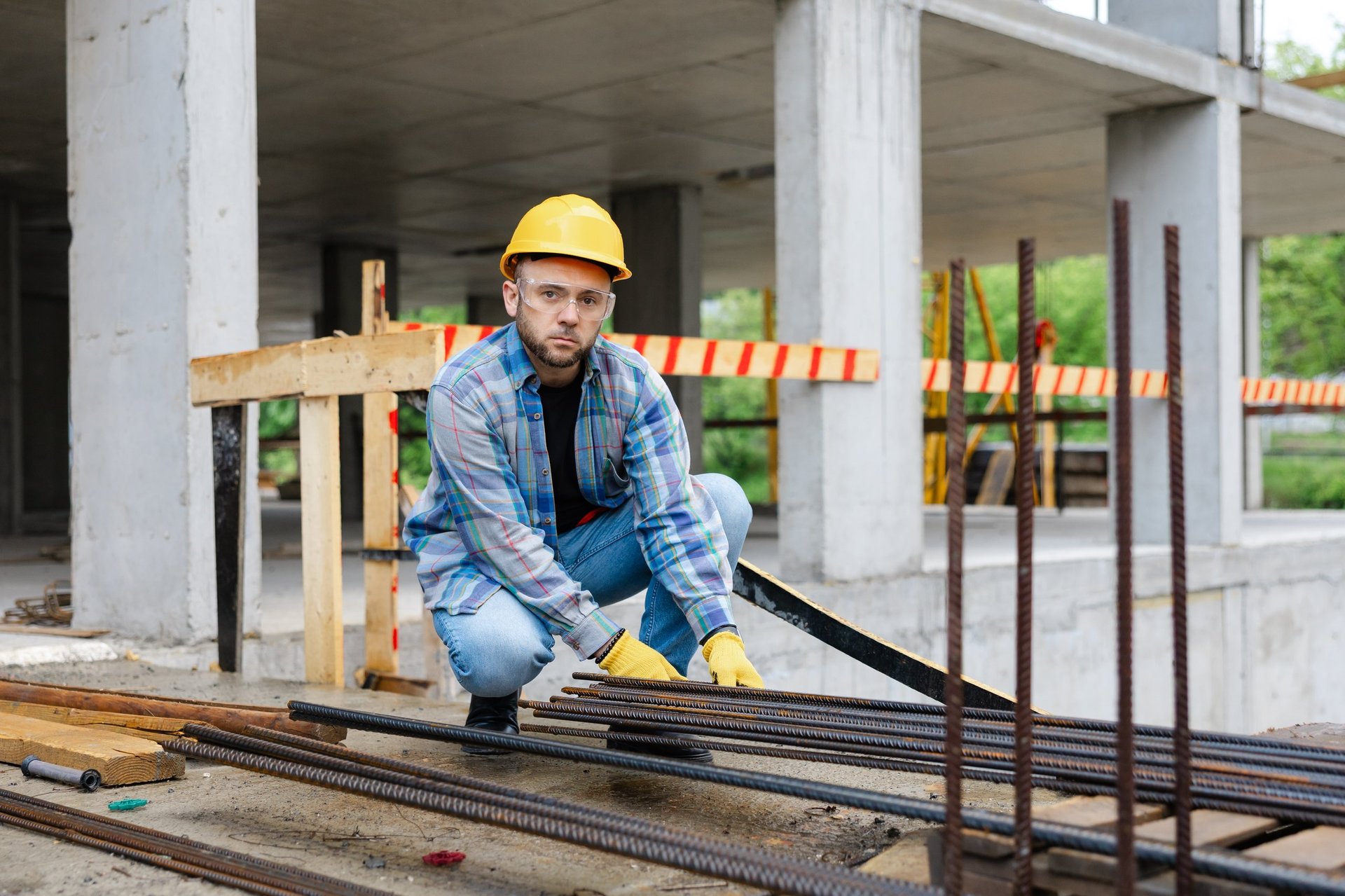 Inspector checking the surface condition of coated reinforcement against the specified protection system before a bridge pour
