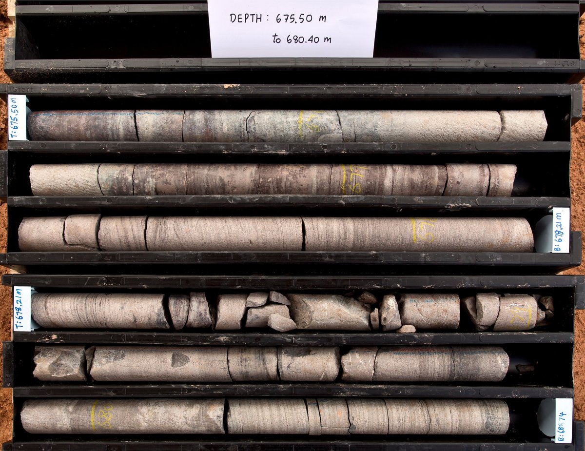 Stacked geological core samples in wooden trays, used to define a sampling boundary before testing